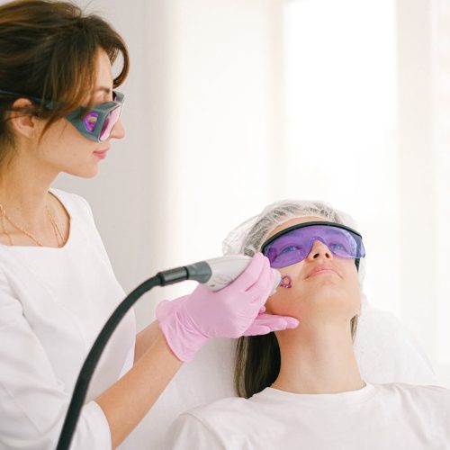 Cosmetologist Performing Scar Whitening on a Woman